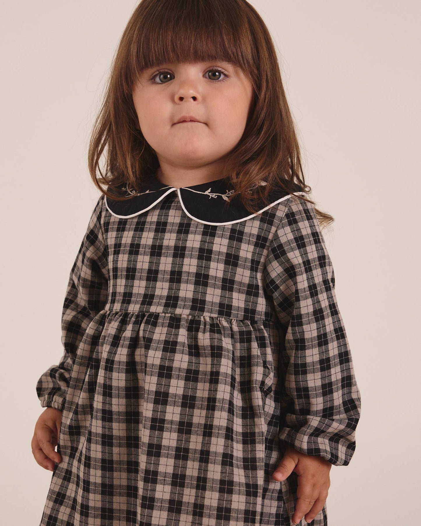 Robe pour bébé en beige clair et carreaux noirs